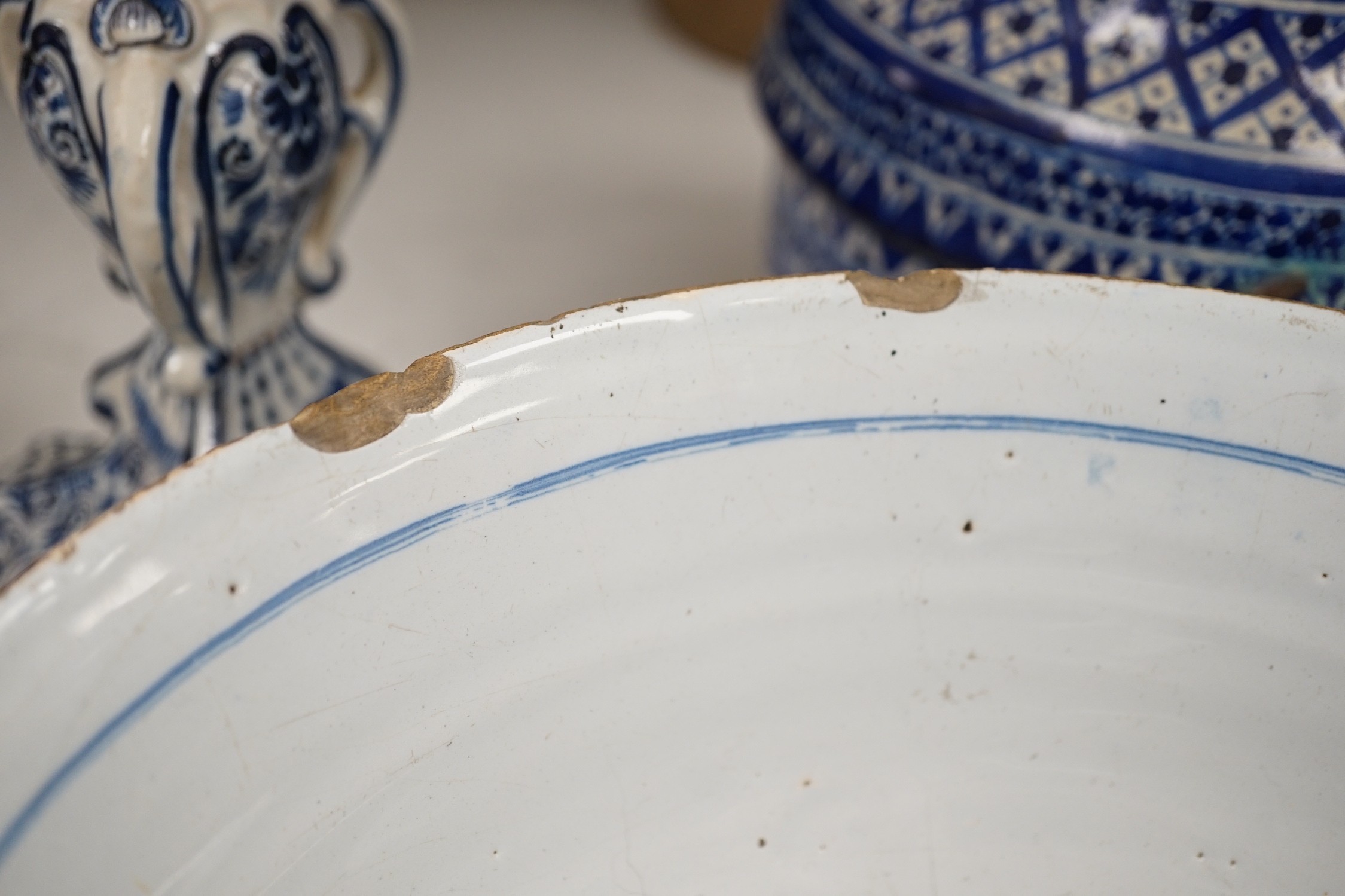 A pair of Delft blue and white candlesticks together with an 18th century Delft bowl, a Moroccan pottery jar with cover, and two pearlware bowls